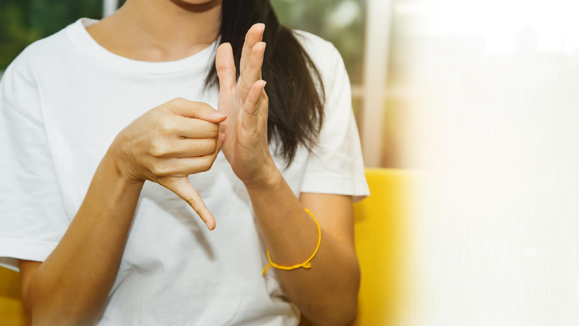 Photo of a pair of hands communicating using sign language