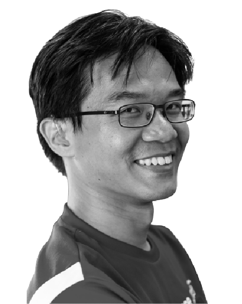 Black and white photo of Alvan Yap, he is smiling, has short hair and is wearing a t-shirt